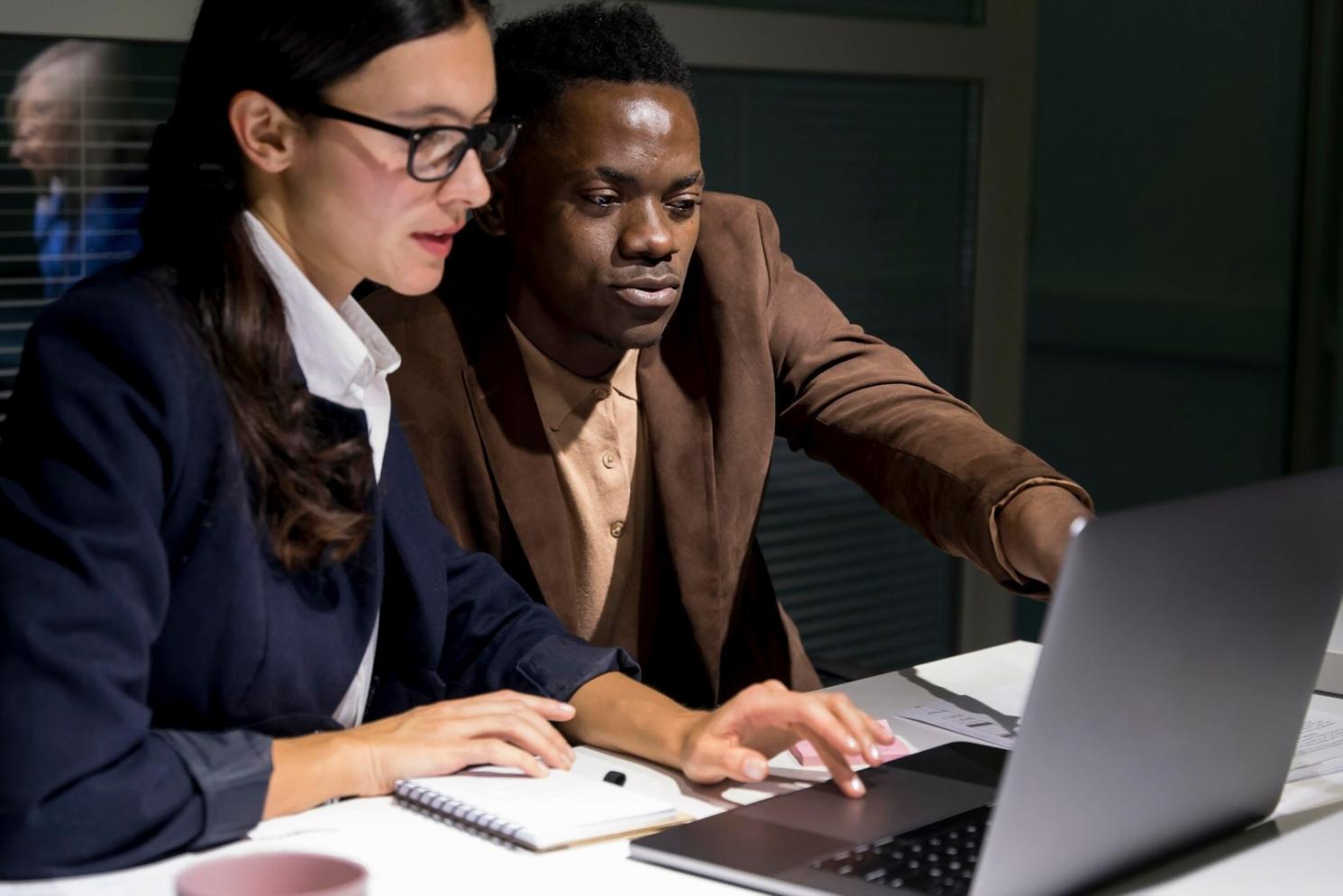 Business professionals collaborating on financial recovery strategies in modern office setting